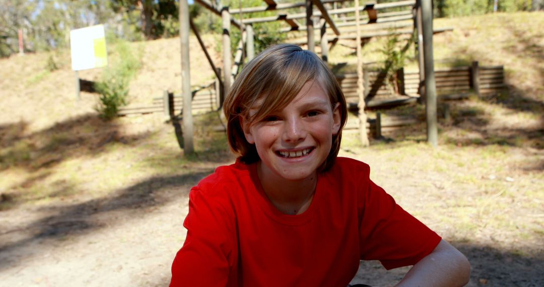 Young Boy Smiling at Outdoor Park in Red Shirt - Free Images, Stock Photos and Pictures on Pikwizard.com