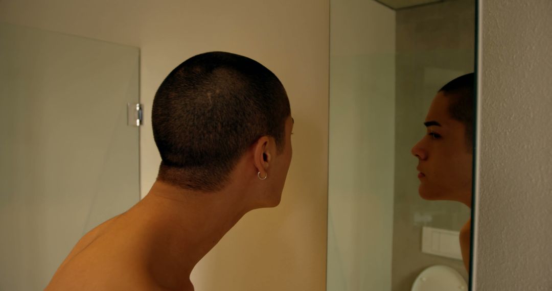 Young Man Examining Reflection in Bathroom Mirror - Free Images, Stock Photos and Pictures on Pikwizard.com