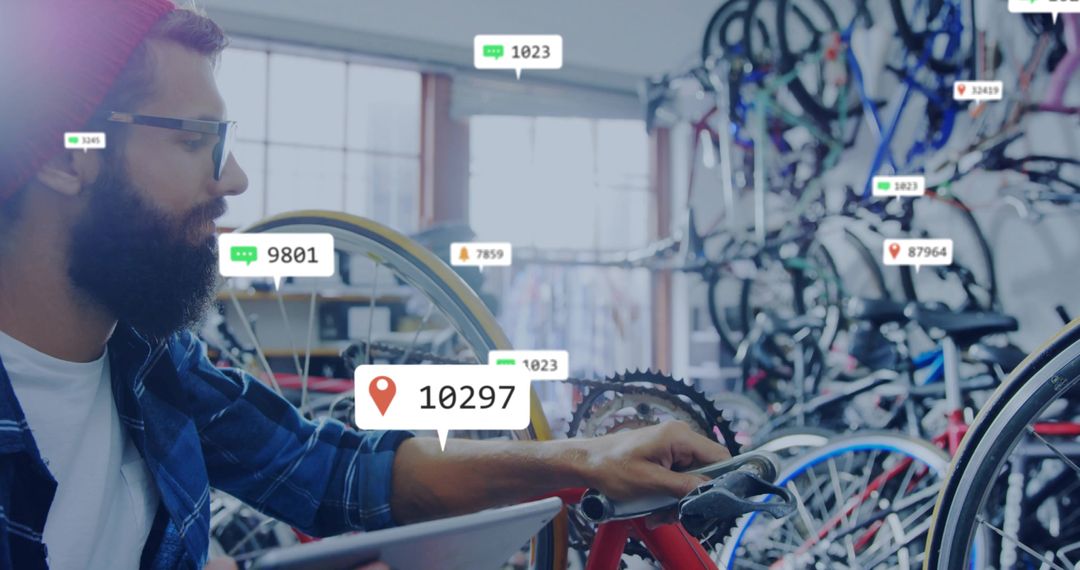 Bicycle Mechanic Utilizing Technology Amidst Busy Bike Workshop