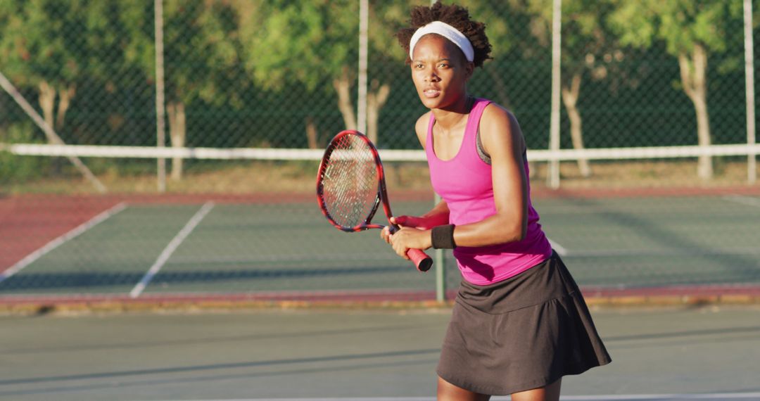 Female Tennis Player on Court in Concentration Stance - Free Images, Stock Photos and Pictures on Pikwizard.com