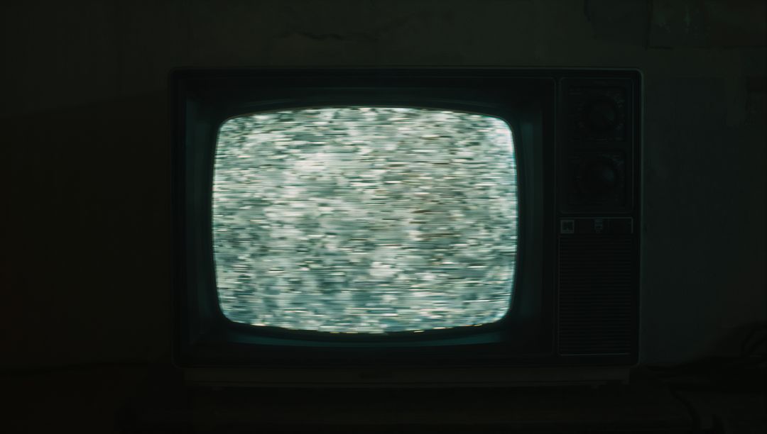 Retro Television with Static Screen in Dimly Lit Basement