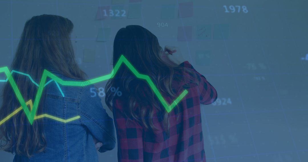 Two Women Analyzing Data Trends on Interactive Display
