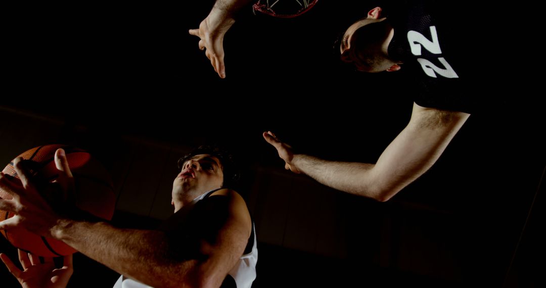 Intense Basketball Match Between Two Players in Indoor Arena