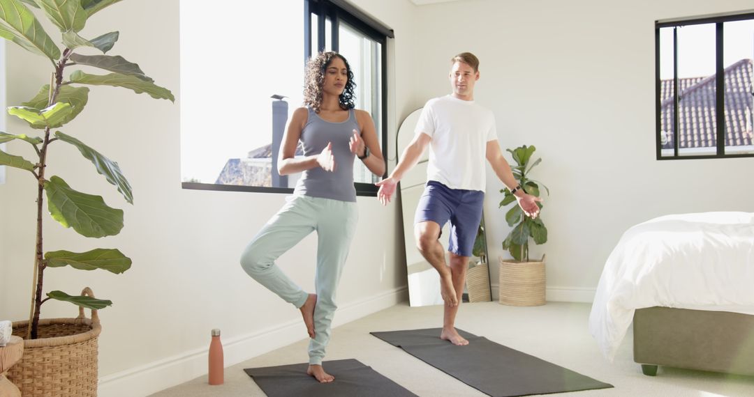 Couple Practicing Tree Pose for Relaxation and Balance in Modern Bedroom