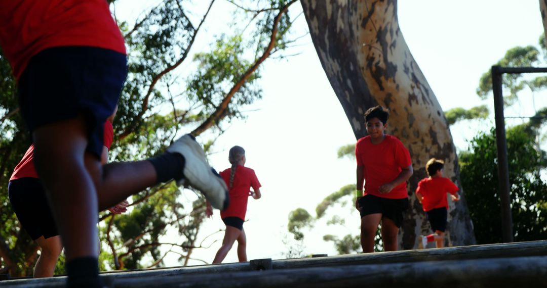 Children Running Outdoor Obstacles Wearing Red T-Shirts - Free Images, Stock Photos and Pictures on Pikwizard.com