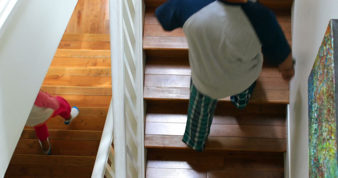 Children Running Down Wooden Stairs in Cozy Home - Free Images, Stock Photos and Pictures on Pikwizard.com