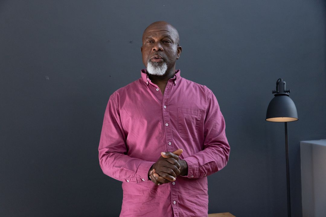 Senior Man Speaking in Modern Studio Environment