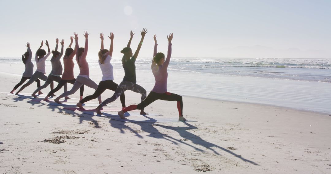 Group Doing Yoga Poses on Beach With Ocean View - Free Images, Stock Photos and Pictures on Pikwizard.com