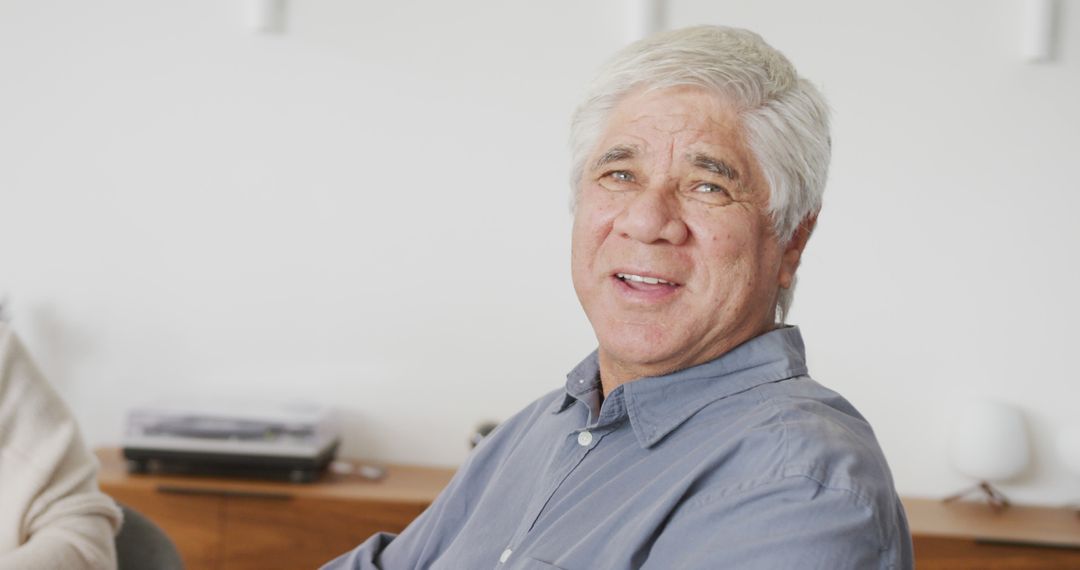 Smiling Elderly Man with Gray Hair and Blue Shirt in Bright Room - Free Images, Stock Photos and Pictures on Pikwizard.com