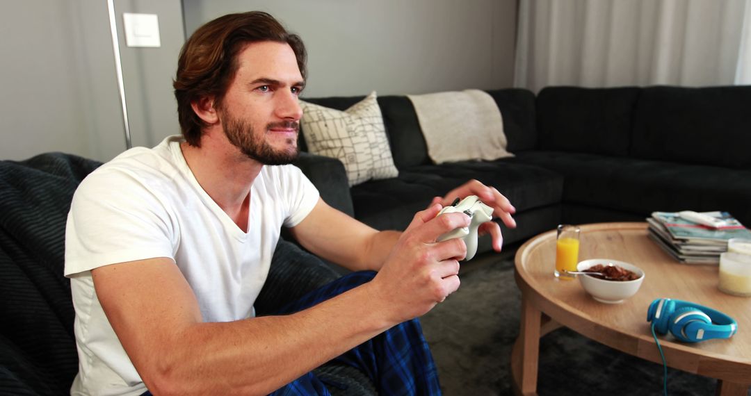 Relaxed Man Playing Video Games in Cozy Living Room - Free Images, Stock Photos and Pictures on Pikwizard.com