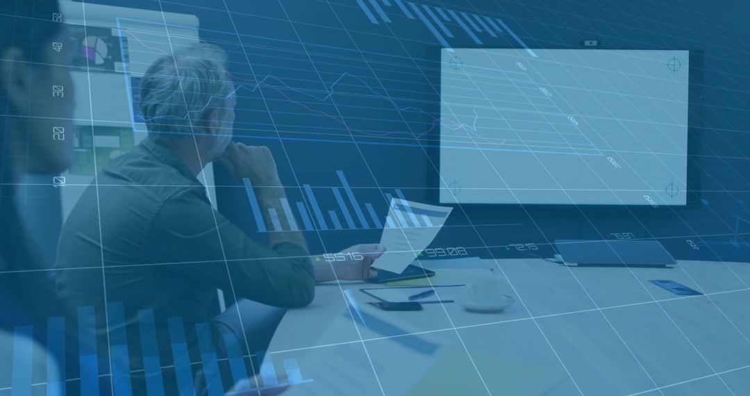 Senior Executive Analyzing Data in Modern Meeting Room