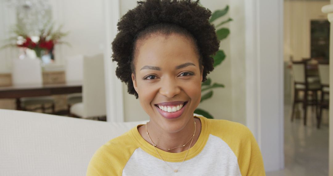Smiling African American Woman Relaxing at Home on Couch