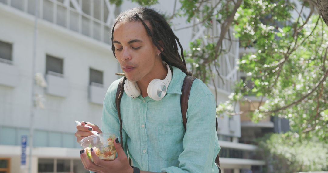 Young Man with Dreadlocks Eating Salad Outdoors - Free Images, Stock Photos and Pictures on Pikwizard.com