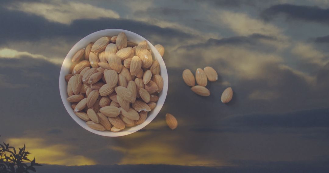 Organic Almonds in Bowl Reflecting Serene Evening Sky