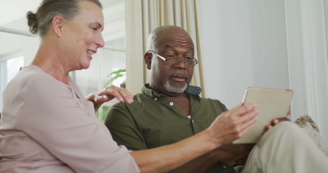 Senior Couple Using Tablet at Home