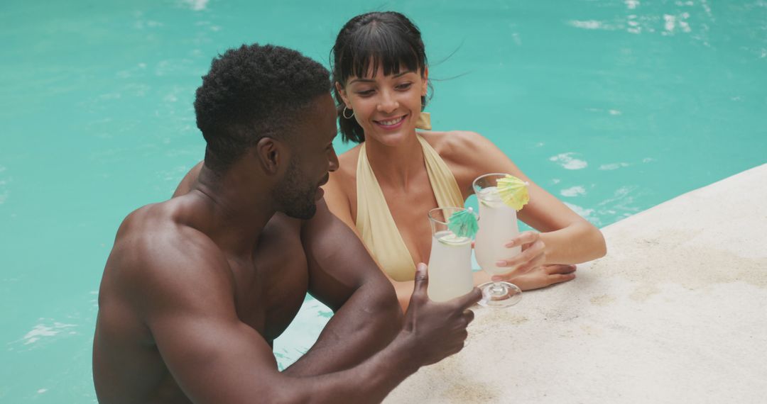 Couple Enjoying Tropical Cocktails in Swimming Pool - Free Images, Stock Photos and Pictures on Pikwizard.com