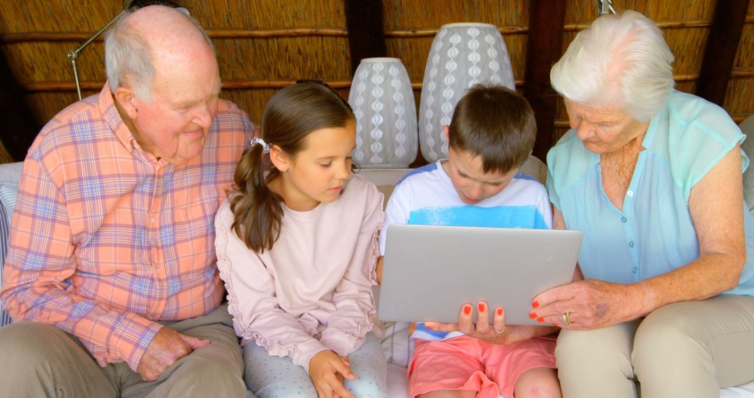 Grandparents Spending Quality Time with Grandchildren Using a Laptop - Free Images, Stock Photos and Pictures on Pikwizard.com