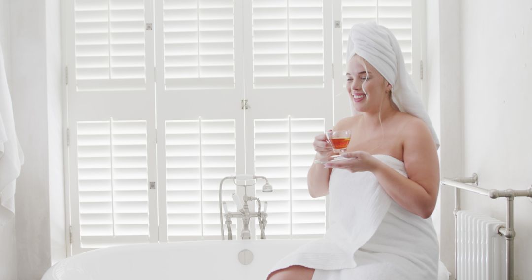 Woman Relaxing After Bath with Tea in Bright Bathroom - Free Images, Stock Photos and Pictures on Pikwizard.com