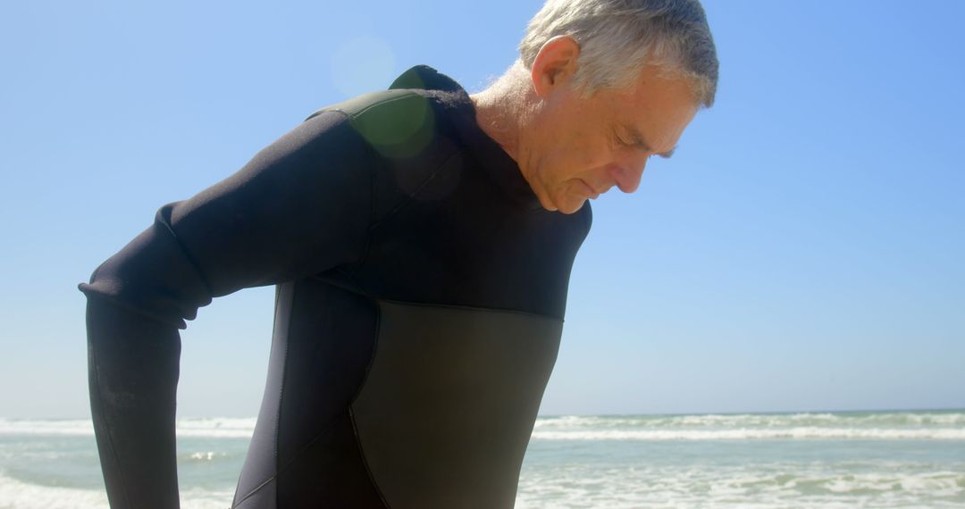 Senior Surfer in Wetsuit Preparing for Beach Adventure
