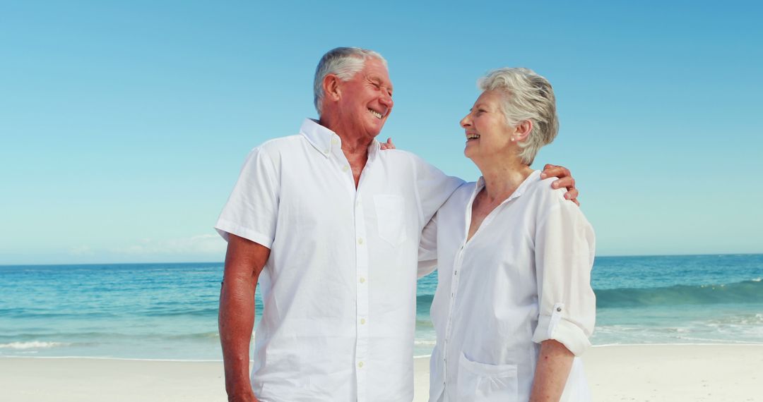 Senior Couple Enjoying Beach Vacation in Bright Daylight - Free Images, Stock Photos and Pictures on Pikwizard.com