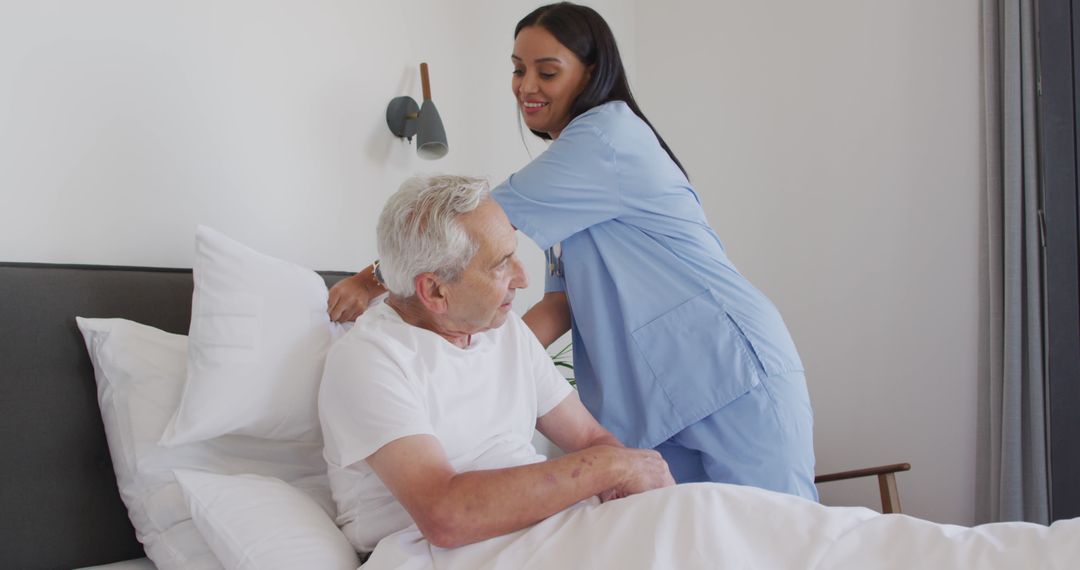 Female Nurse Assisting Elderly Man in Bed at Home - Free Images, Stock Photos and Pictures on Pikwizard.com