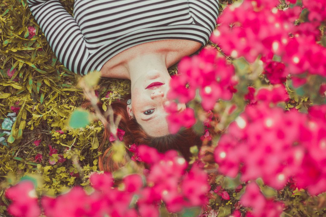 Woman Lying Among Colorful Flowers in Striped Shirt - Free Images, Stock Photos and Pictures on Pikwizard.com