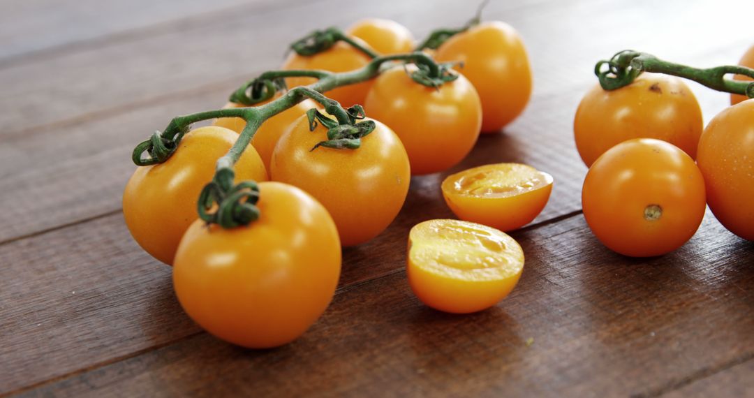 Vibrant yellow cherry tomatoes, perfect for salads and gourmet meals, are displayed on wood. - Free Images, Stock Photos and Pictures on Pikwizard.com