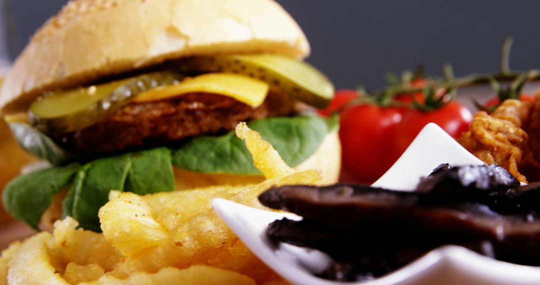 Close-Up of Gourmet Burger with Crispy Fries and Vegetables - Free Images, Stock Photos and Pictures on Pikwizard.com