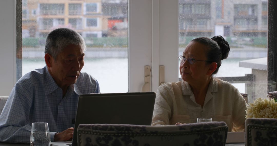 Senior Couple Engaging with Technology in Cozy Home Setting