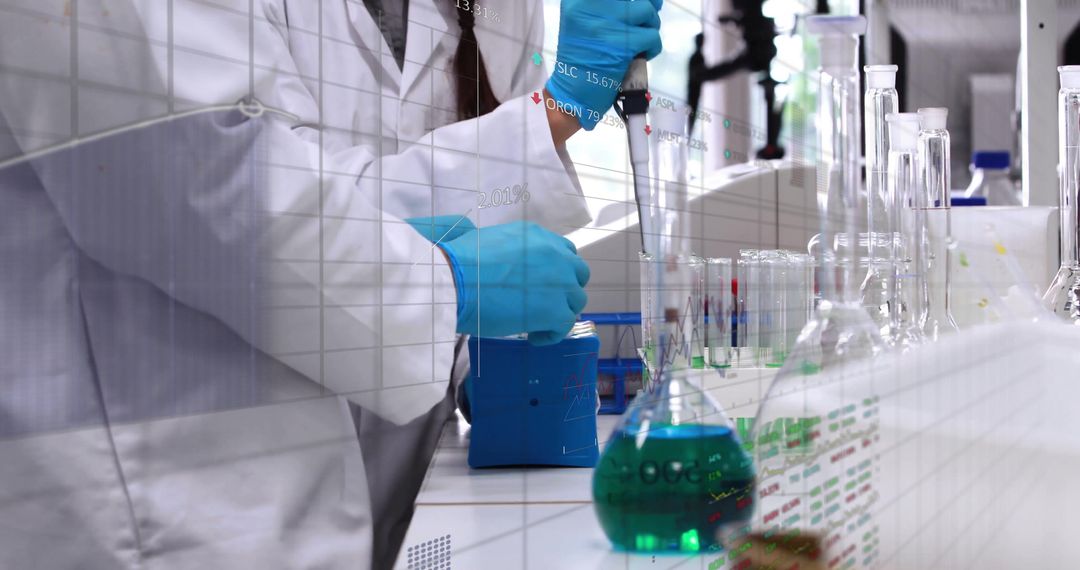 Scientist Using Micropipette Preparing Green Solution in Laboratory