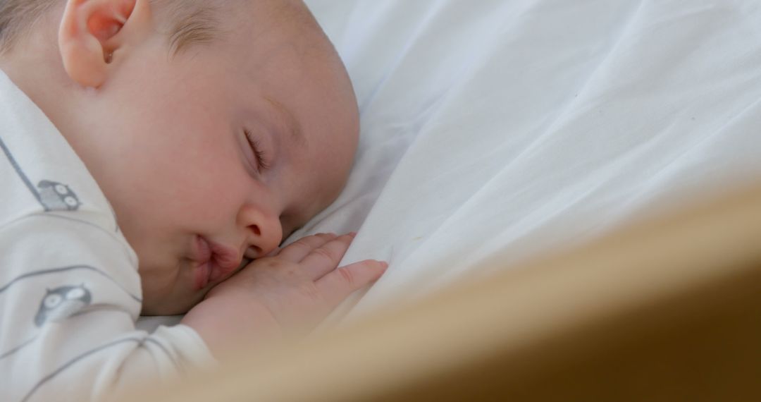 Peaceful Newborn Baby Sleeping on Soft White Bed - Free Images, Stock Photos and Pictures on Pikwizard.com