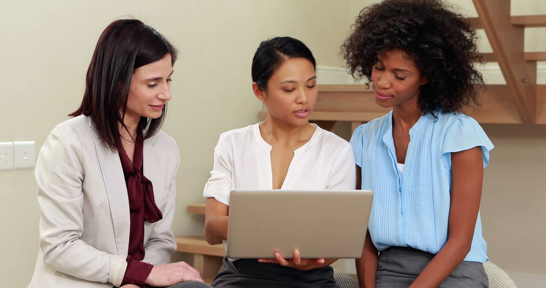 Collaborative Businesswomen Using Laptop for Teamwork