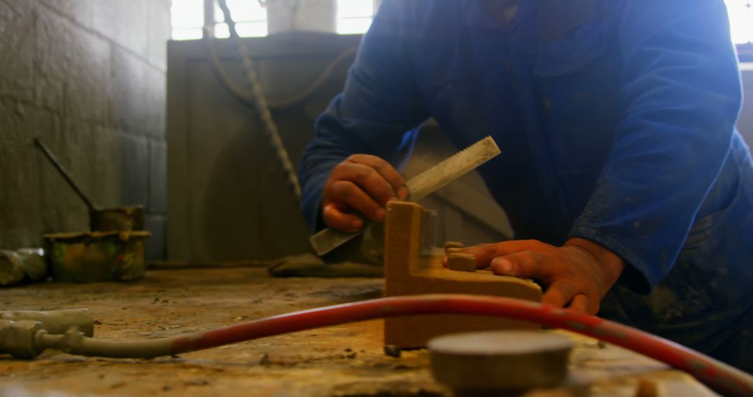 Manual Worker Using Hand Tools in Workshop - Free Images, Stock Photos and Pictures on Pikwizard.com