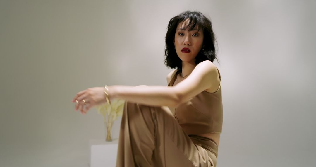 Elegantly Dressed Woman in Minimalist Studio Setting