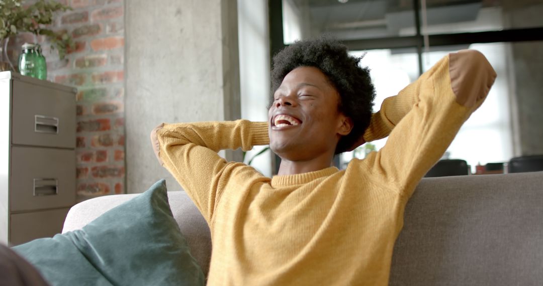 Joyful African American Man Relaxing on Sofa at Home - Free Images, Stock Photos and Pictures on Pikwizard.com