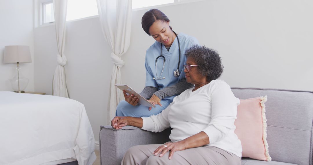 Healthcare Professional Discussing Report with Elderly Patient at Home - Free Images, Stock Photos and Pictures on Pikwizard.com