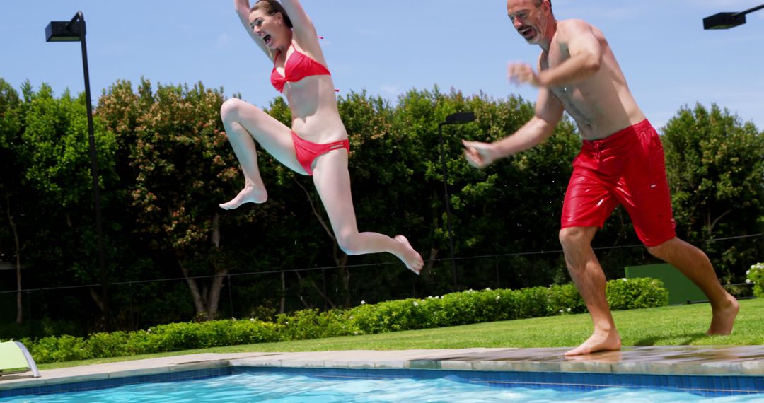 Father and Daughter Enjoying Pool Jump on Sunny Day - Free Images, Stock Photos and Pictures on Pikwizard.com