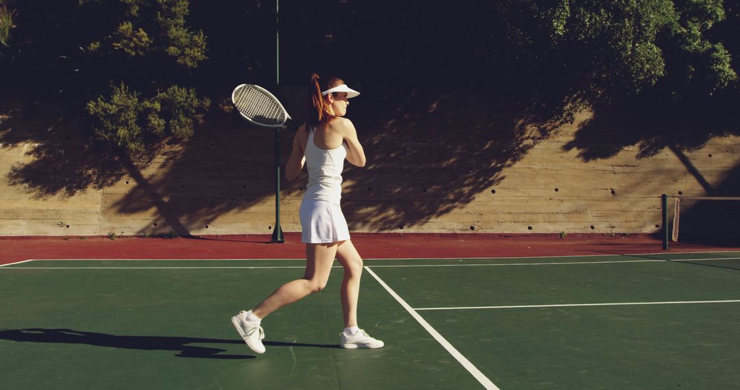A young Caucasian woman is playing tennis on a court, with copy space - Free Images, Stock Photos and Pictures on Pikwizard.com