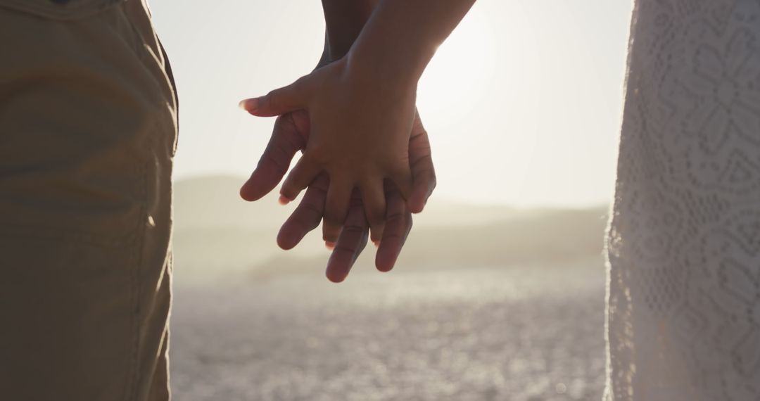 Close-up Hands of Couple Holding Together at Beach Sunset - Free Images, Stock Photos and Pictures on Pikwizard.com