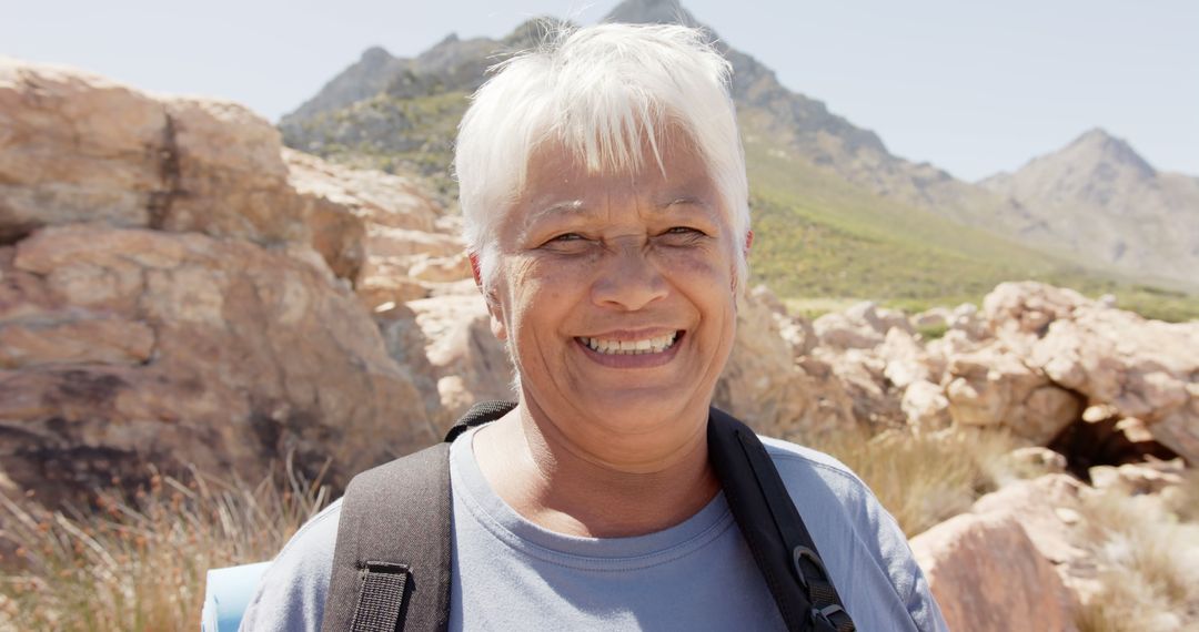 Senior Woman Hiking in Mountain Landscape with Backpack - Free Images, Stock Photos and Pictures on Pikwizard.com