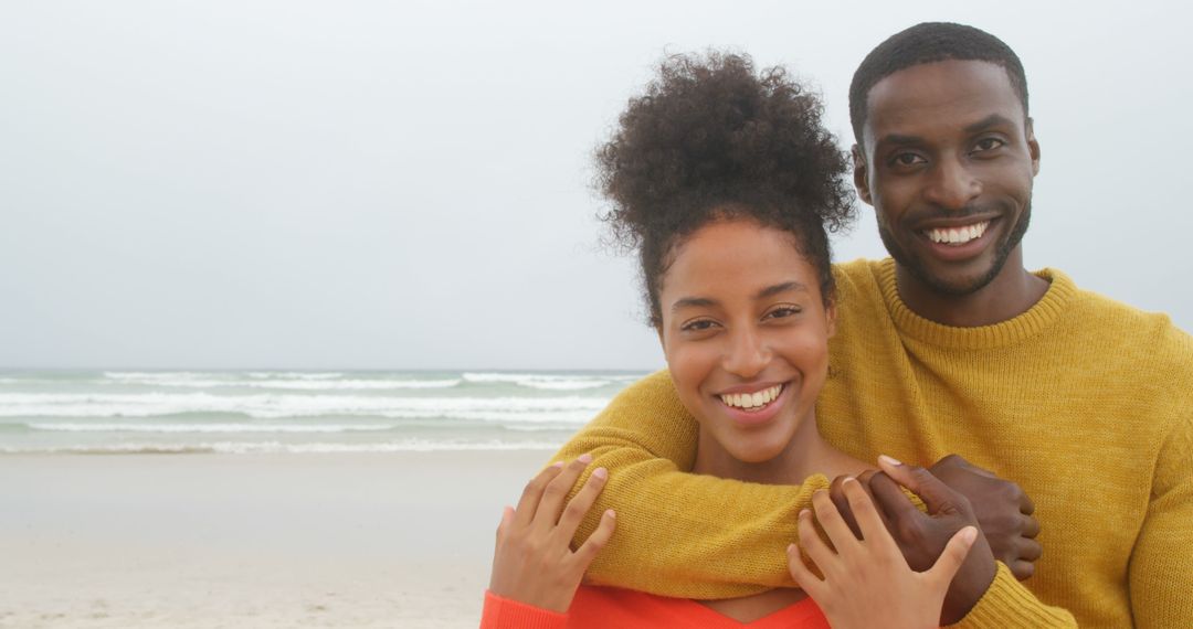 Smiling Couple Embracing on Beach - Free Images, Stock Photos and Pictures on Pikwizard.com