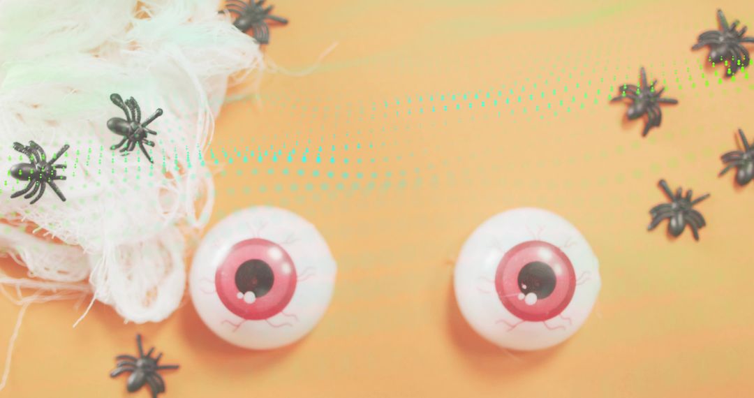 Halloween Eyeballs and Spiders Flatlay with Gauze on Orange Background