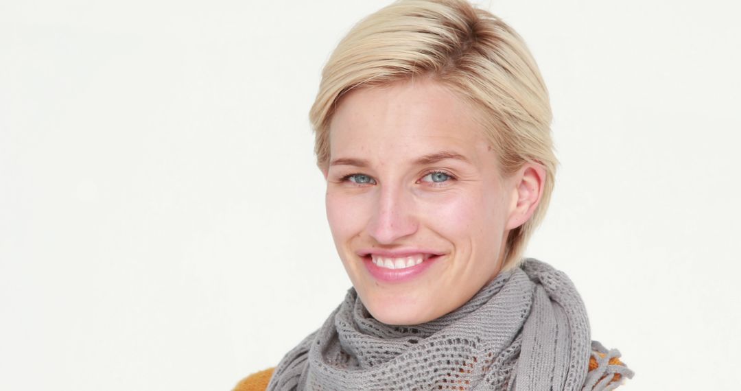 Smiling Woman with Short Blonde Hair Wearing Grey Scarf - Free Images, Stock Photos and Pictures on Pikwizard.com