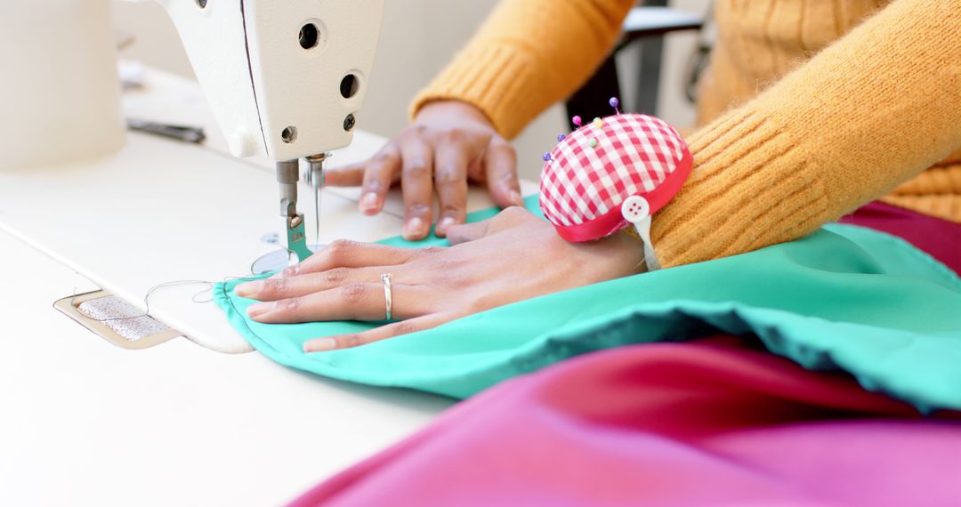 Close-up of Seamstress Sewing Colorful Fabric with Sewing Machine - Free Images, Stock Photos and Pictures on Pikwizard.com