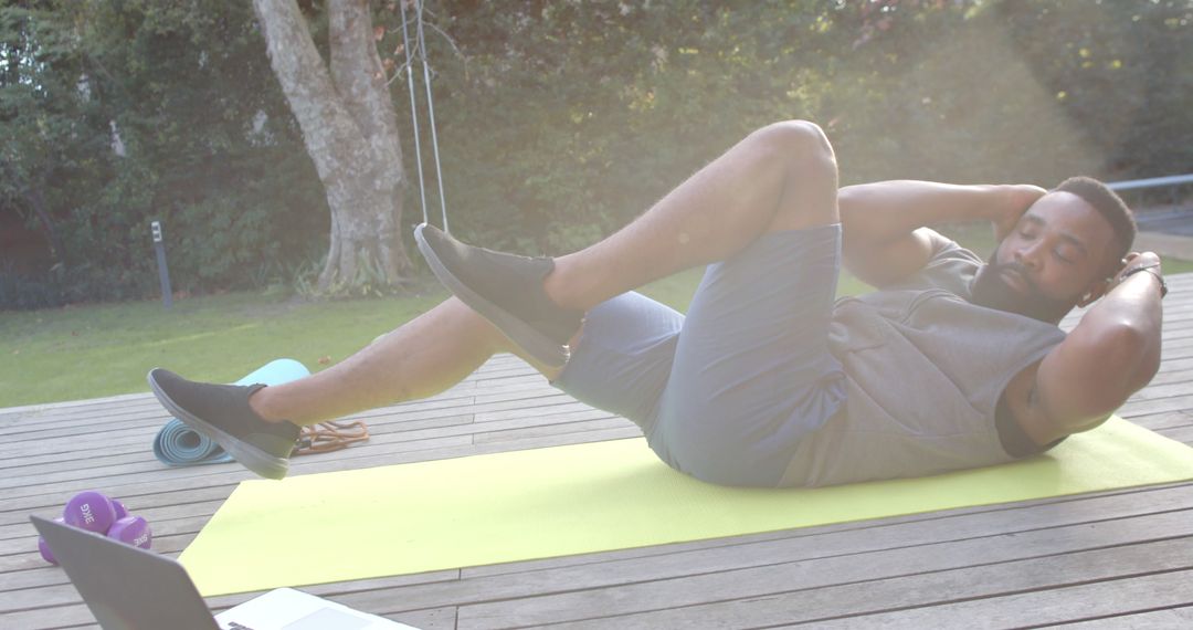 Man Exercising Outdoors Doing Bicycle Crunches on Yoga Mat - Free Images, Stock Photos and Pictures on Pikwizard.com