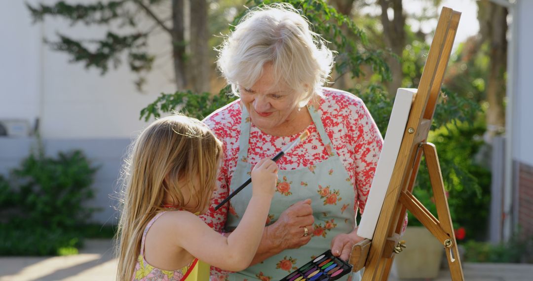 Grandmother and Granddaughter Enjoying Time Painting Outdoors - Free Images, Stock Photos and Pictures on Pikwizard.com