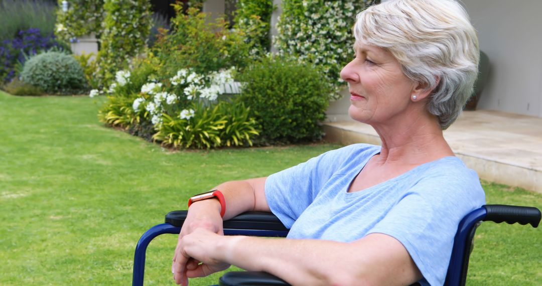 Senior Woman Relaxing in Wheelchair in Garden with Eyes Closed - Free Images, Stock Photos and Pictures on Pikwizard.com