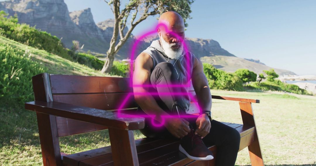 Elderly Man Tying Running Shoe Laces in Scenic Park