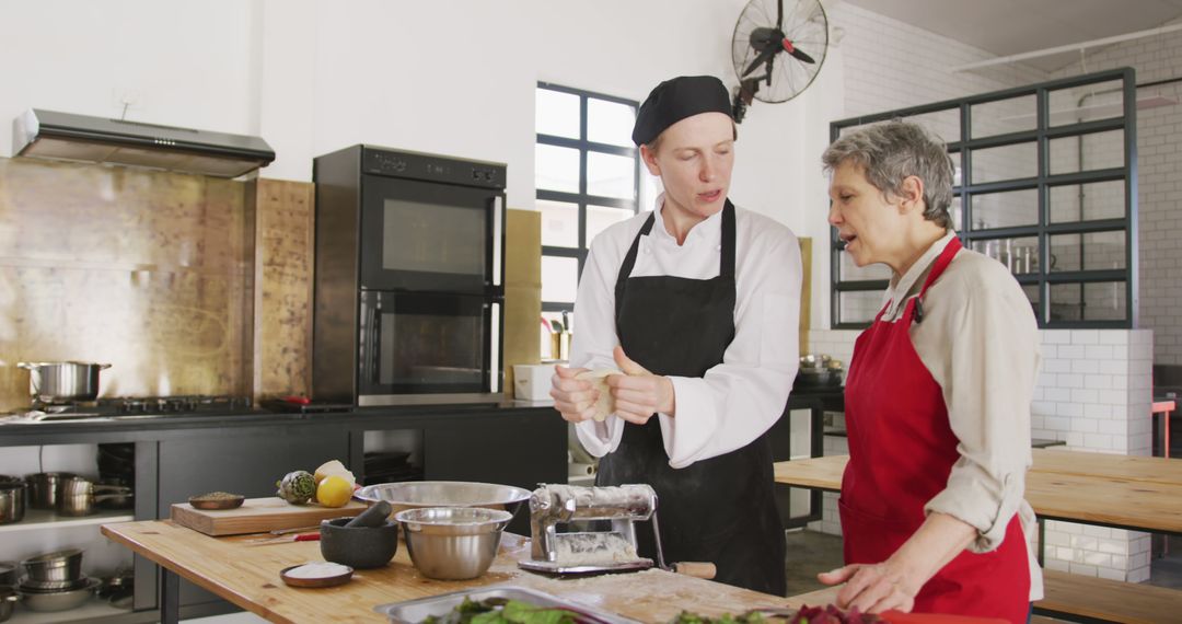 Professional Chef Teaching Senior Woman Cooking Techniques in Modern Kitchen - Free Images, Stock Photos and Pictures on Pikwizard.com