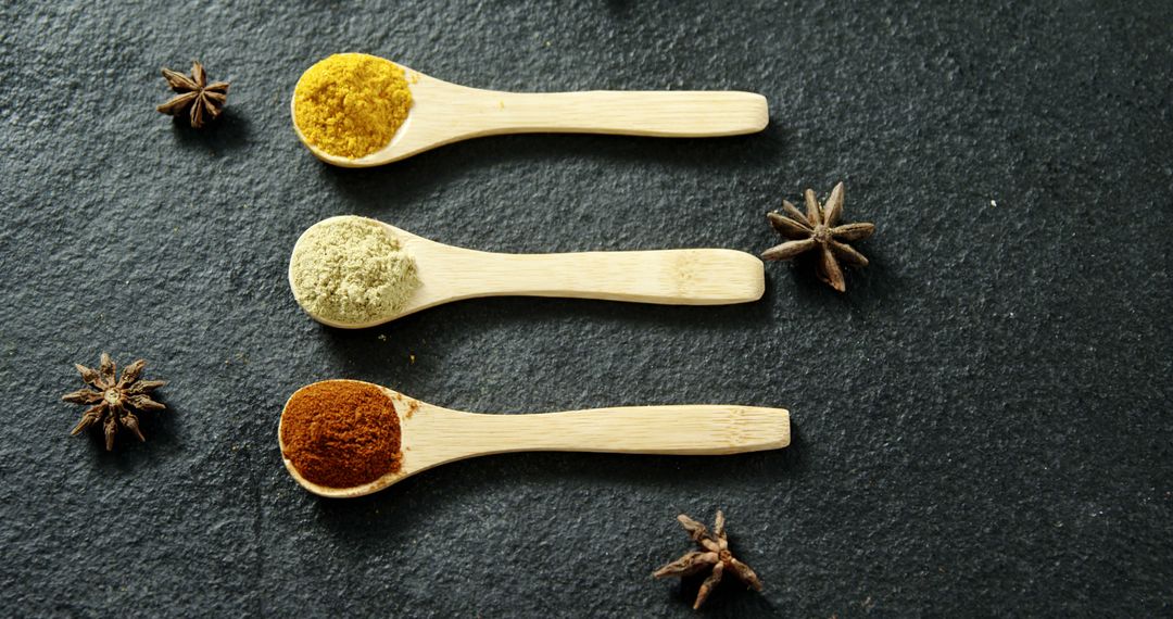 Assorted Spices in Wooden Spoons on Black Stone Background - Free Images, Stock Photos and Pictures on Pikwizard.com